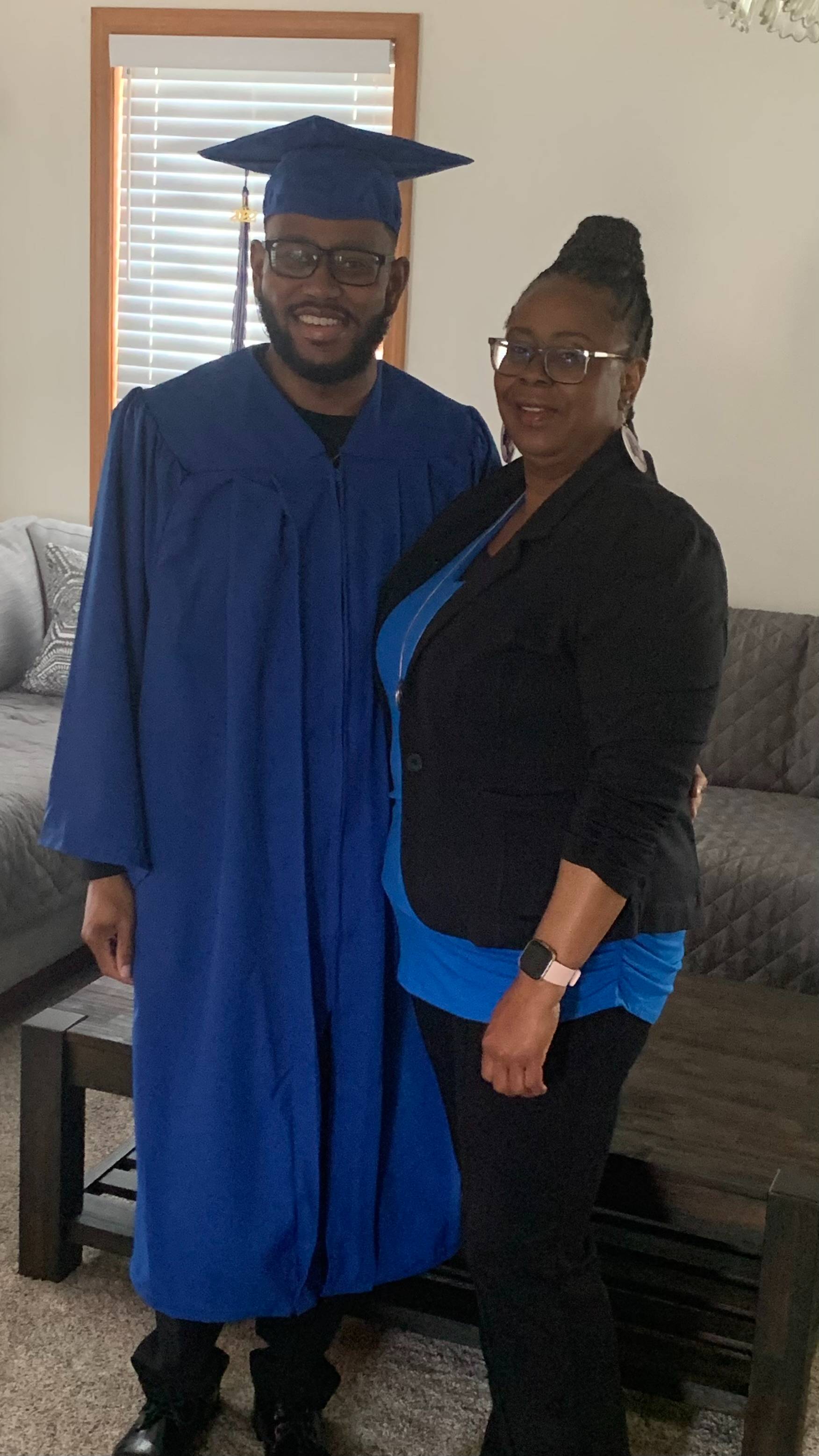 Tina Lee standing and smiling with her son, Daniel, in his cap and gown
